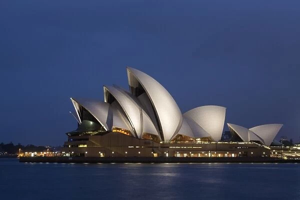 View of performing arts centre illuminated at night, Sydney Opera House, Sydney Harbour, Sydney, New South Wales