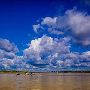 Family on a canoe, Amazon River, Iquitos, Peru, South America