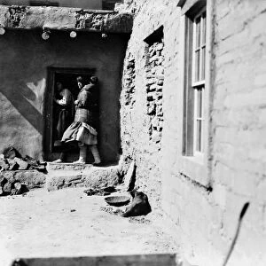 ZUNI PUEBLO, c1903. Zuni Native Americans in a doorway in a pueblo village in the