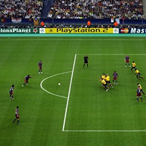 Arsenals wall rushes to charge down Ronaldinho (Barca) shot