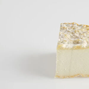 Slice of French Abbaye de la Pierre-qui-Vire cows milk cheese