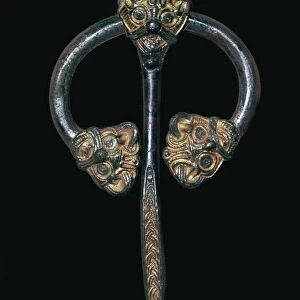 Viking gilded bronze dress fastener, 9th century