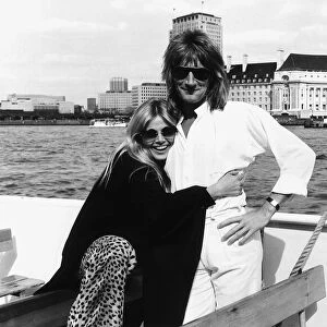 Rod Stewart singer with girlfriend Brit Ekland pose for a photograph during a boat trip