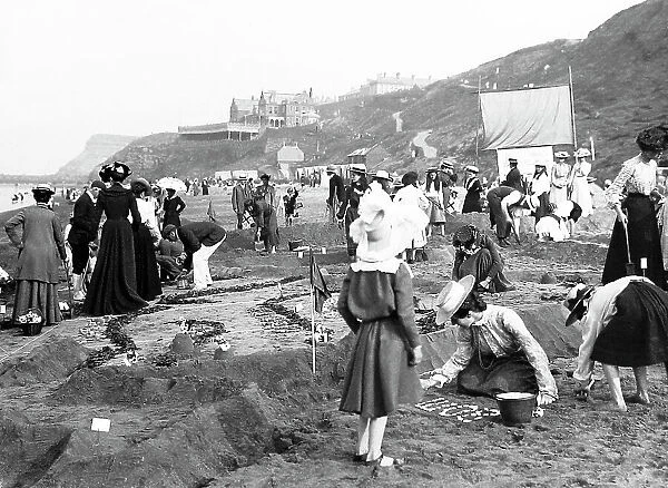 Children on Whitby Sands making a sand map of India