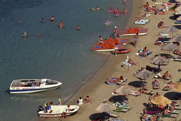 Aerial view over boats and people on a crowded beach