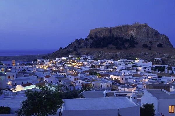 Aerial view over the town and acropolis of Lindos Town at dusk