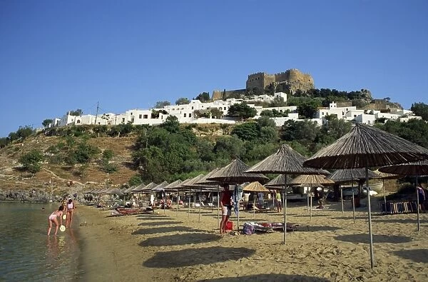 The beach below the white houses and acropolis of Lindos Town