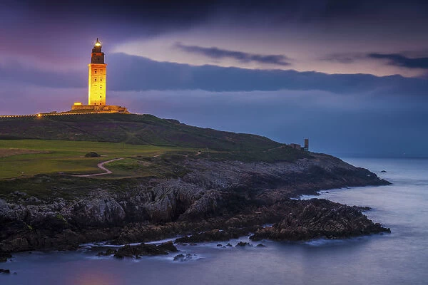 Spain, Galicia, La Coruna, Torre de Hercules illuminated at night