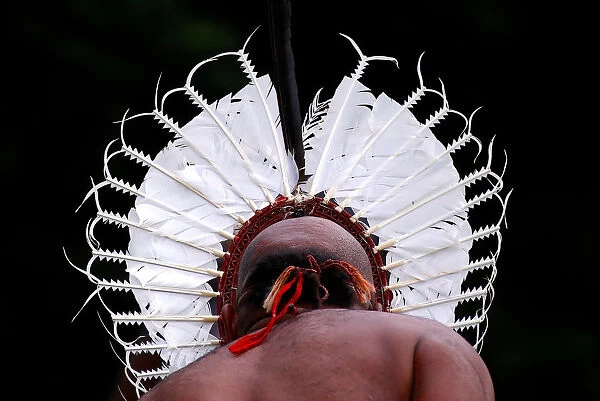 An indigenous man from the Torres Strait Islands wears a traditional dress as he performs