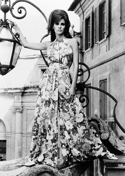 RAQUEL WELCH (1940-). American singer and actress. Posing next to a lantern in Rome, Italy