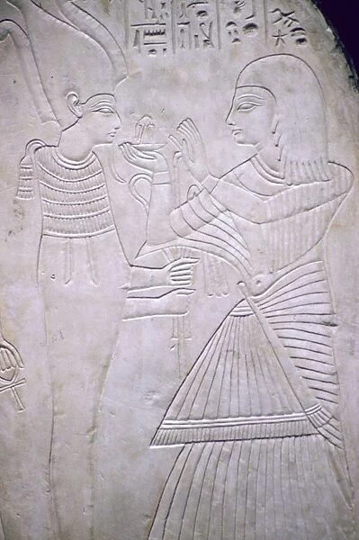 Egyptian relief of Amon making an offering to Osiris