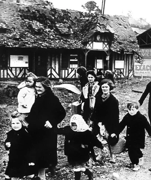 Families leaving their village bombarded during the Normandy landings, France, 1944
