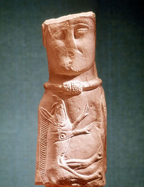 Stone carving of Celtic deity wearing a torque