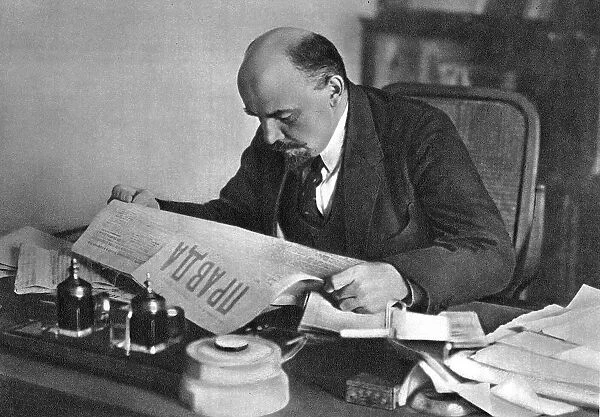 Vladimir Ilyich Ulyanov (Lenin), Russian Bolshevik revolutionary, reading Pravda, 1918