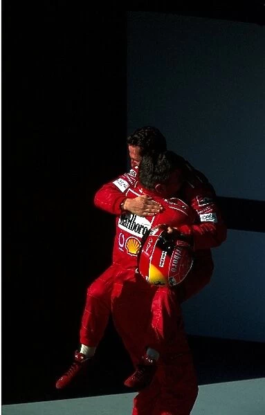Formula One World Championship: Ferrari Technical Director Ross Brawn congratulates his winning driver Michael Schumacher