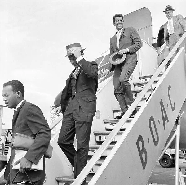 American musician and screen legend Frank Sinatra descends the steps of the plane as he