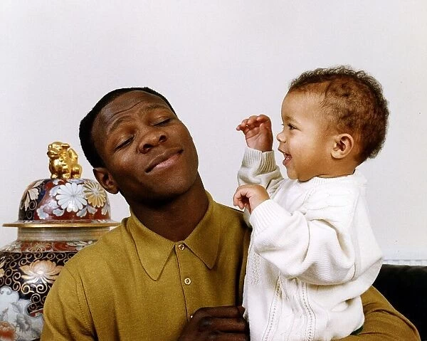 Chris Eubank boxer holding his baby in his arms