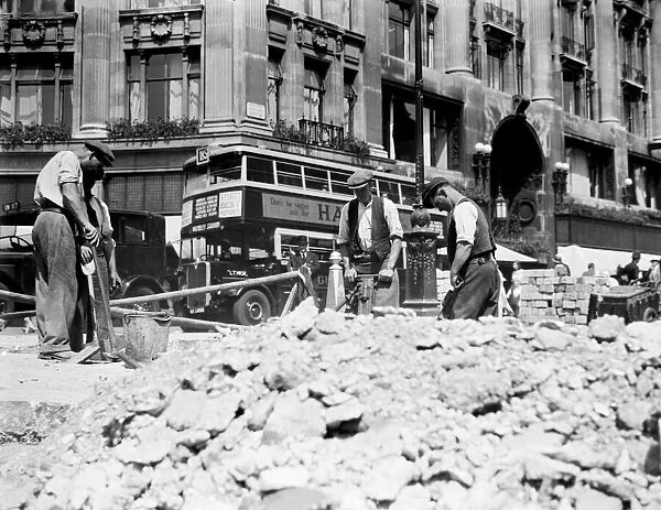 Road workers, digging up the road at Oxford Street, London