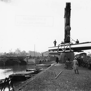 Transferring a boat from river to rail at the GWR Brent Docks, c1930s