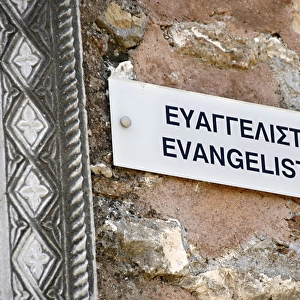 Bilingual poster on the wall of the Church of Evangelistria