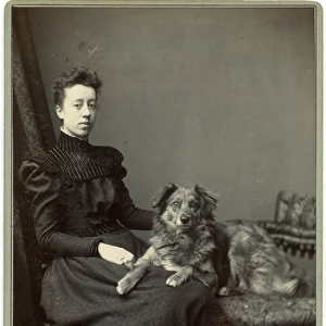 Studio portrait, young woman with dog