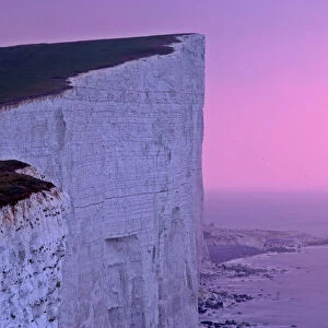 UK - lighthouse at Beachy Head with steep chalk cliffs at sunrise. East Sussex, England, UK