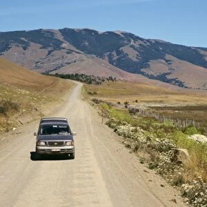 Car driving on a dirt road in Patagonia, Chile, South America