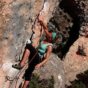 A climber on a route along the arch of El Delphin (The Dolphin) in the Mascun Gorge