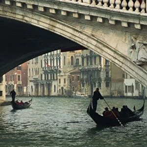 Gondola under the Rialto Bridge on the Grand Canal in Venice