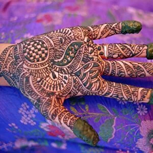 Hand decorated with design in henna