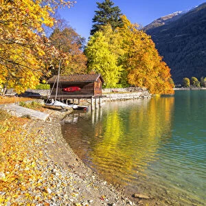 House on stilts on the shore of Lake Poschiavo in autumn, Valposchiavo, Canton of Graubunden, Switzerland, Europe
