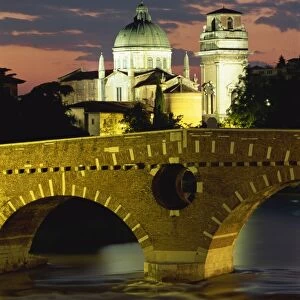 The Ponte Pietra Bridge and Adige River at dusk in the town of Verona