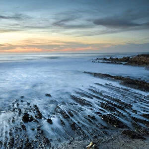 North America, USA, California. Sunset on rock formations with ocean at Montana de Oro State Park