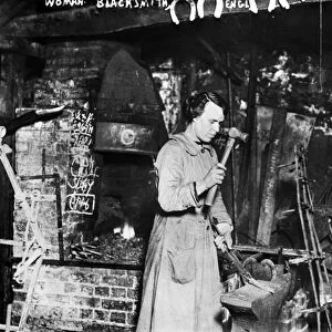 BLACKSMITH: WOMAN. A woman working as a blacksmith, England