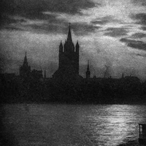 GERMANY: COLOGNE, c1920. The Rhein River and Cologne Cathedral in the evening at Cologne, Germany