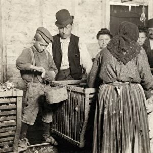 HINE: OYSTER SHUCKERS, 1911. A shucking-boss observing a young boy as he shucks