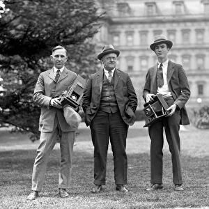 PHOTOGRAPHERS, c1915. Two American photographers with cameras and their subject, c1915