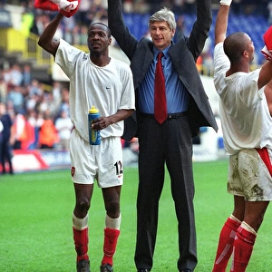Arsene Wenger and Lauren celebrate at the end of the match