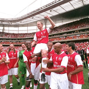 Dennis Bergkamp is chaired by Patrick Vieira and Thierry Henry and the rest of the Arsenal Legends