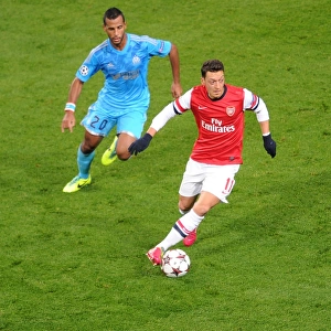 Mesut Ozil vs. Alaixys Romao: A Battle in the Arsenal v Marseille UEFA Champions League Match, 2013