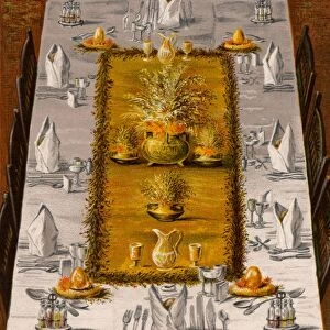 Dinner table arranged for eight. At each corner of the central decoration is a Prices s