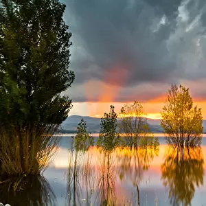 Yellow, Orange, Pink, and Gray Clouds at Sunset over Lake Jindabyne, Australia