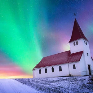 aurora borealis over the church landing on the hill covered by snow, Vik i myrdal church