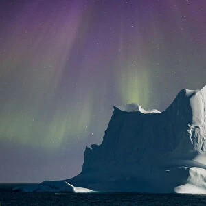 Iceberg shrouded by aurora