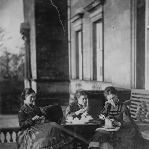 Mother and daughters enjoy their tea outdoors in the afternoon sun