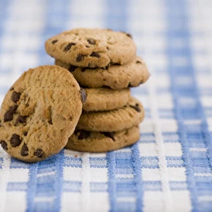 Stack of chocolate chip cookies from supermarket credit: Marie-Louise Avery / thePictureKitchen