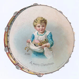 A Victorian die-cut shape Christmas card of a tambourine with an image of a child holding