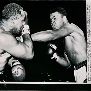 Young Cassius Clay scores with a left against the veteran Archie Moore in the first round of the fight in Los Angeles, 15th November 1962 (b / w photo)