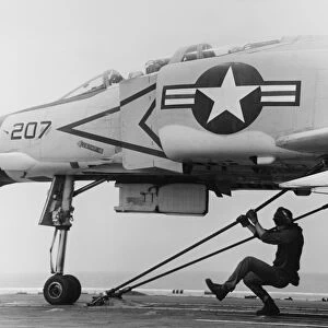 An F-4B Phantom II fighter plane is readied for launch from USS Coral Sea, 1969