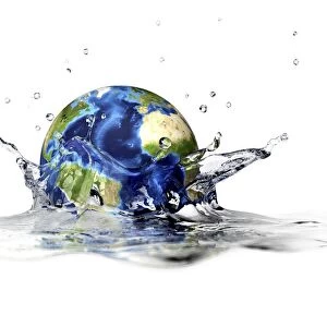 Planet Earth falling into clear water, forming a crown splash